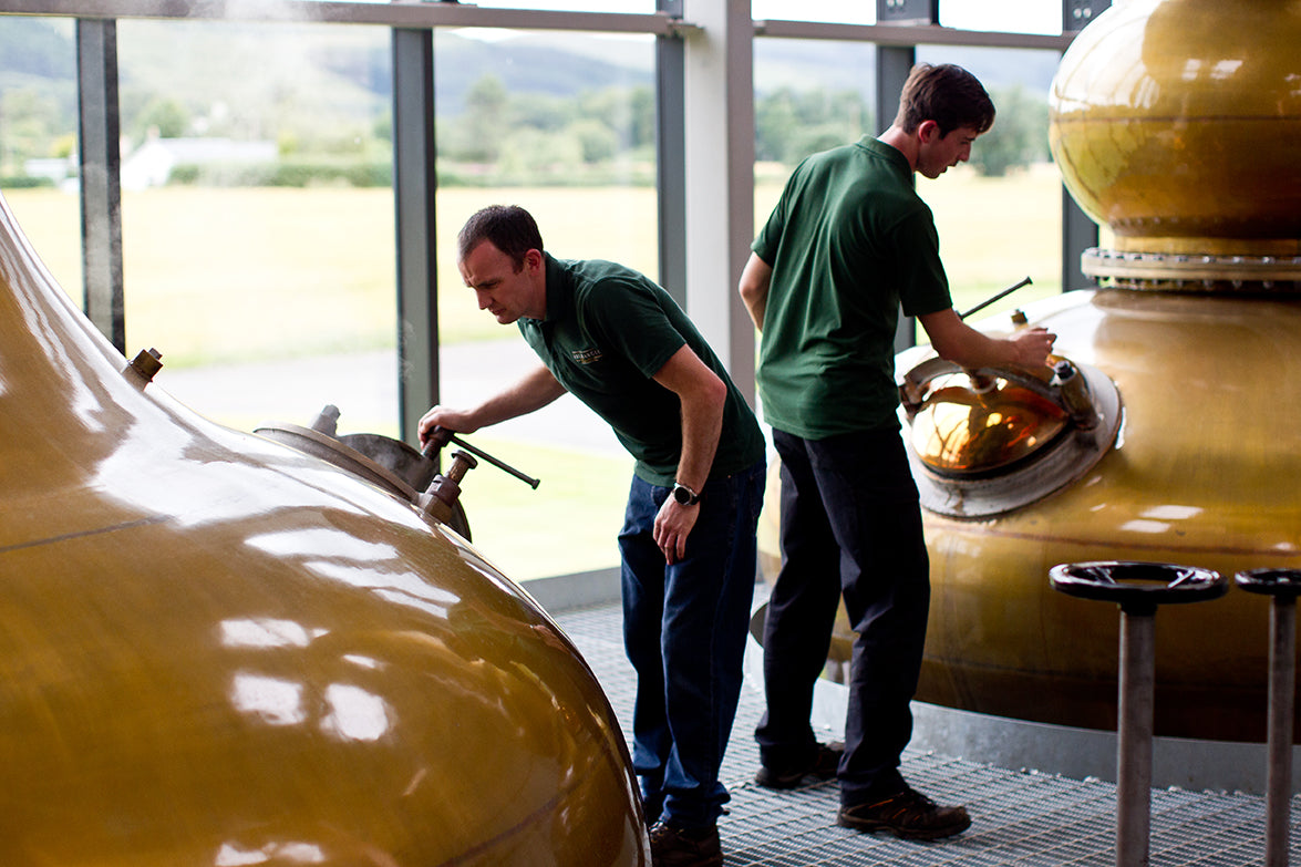 Aberargie team looking at the whisky beside the still